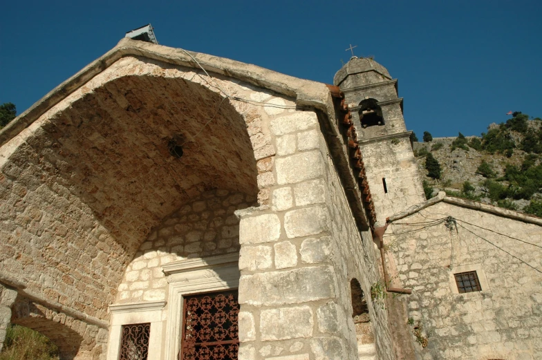 the facade of a church has a window and a door on each side