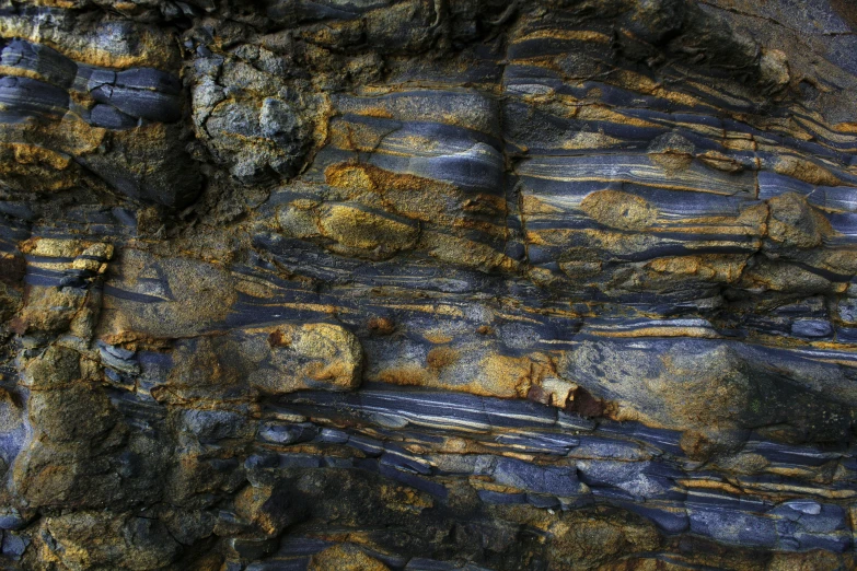 an abstract pattern made from rocks with the background blue and gold