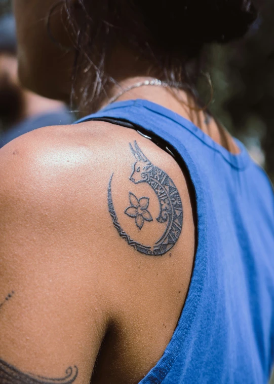 a man with tattoos on his upper arm