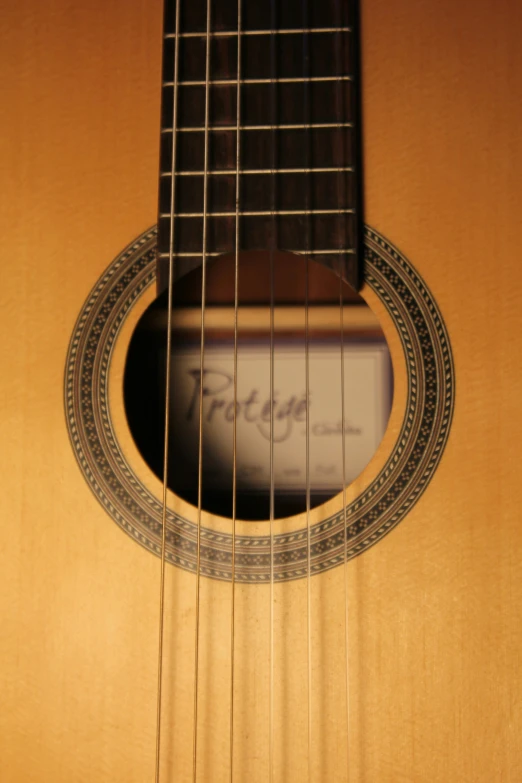 an acoustic guitar neck with strings that are curved