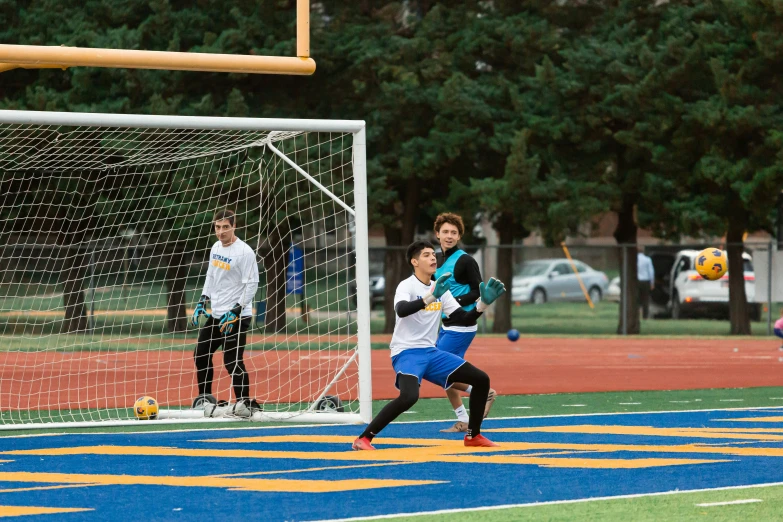 a boy is hitting the ball on the field