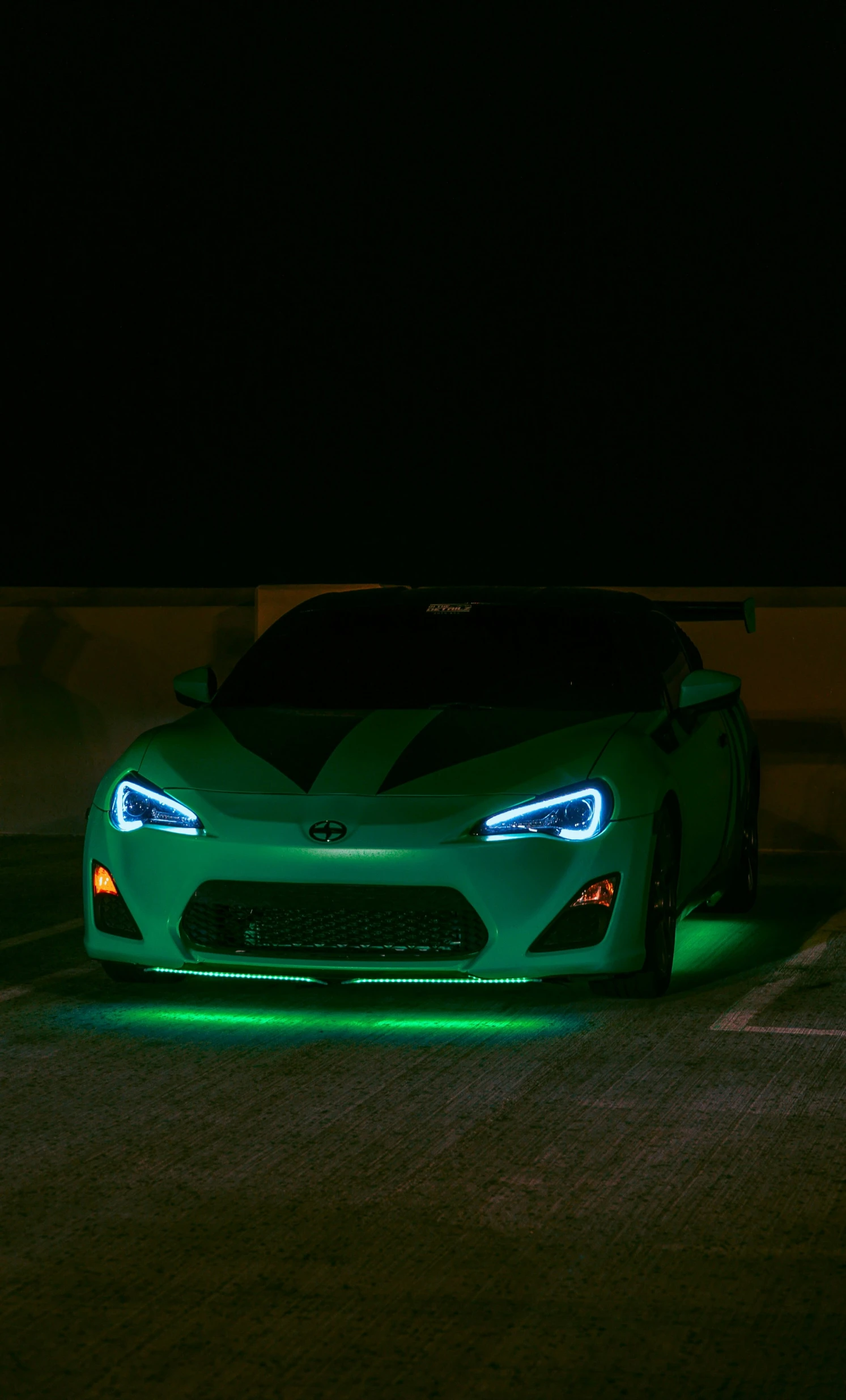 a car is shown at night in the dark