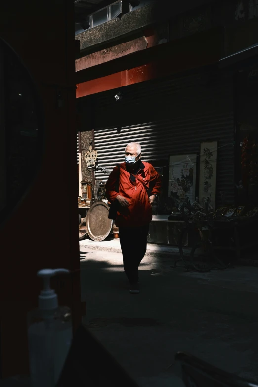 a woman is standing in the street next to a red jacket