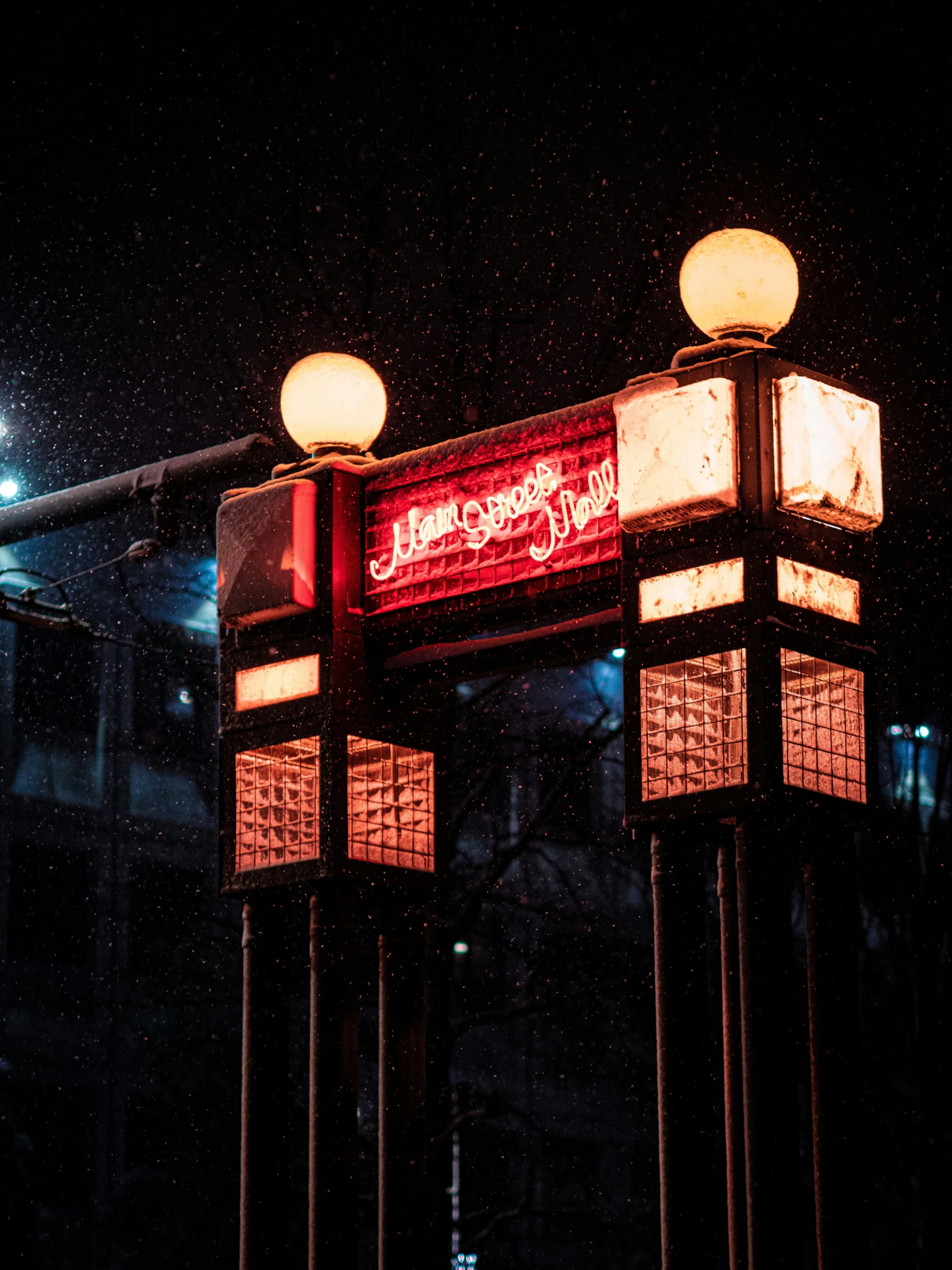 the lights on top of a traffic sign reflect the night sky