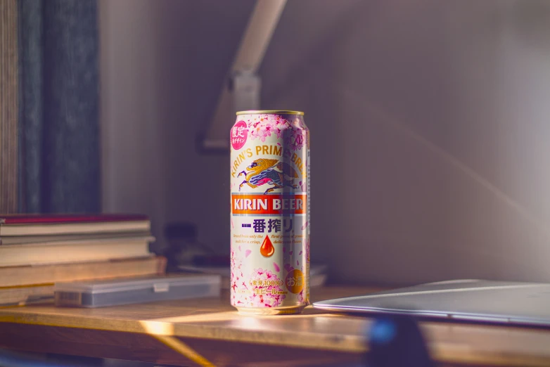 a can of peach blossom with a notebook in the background