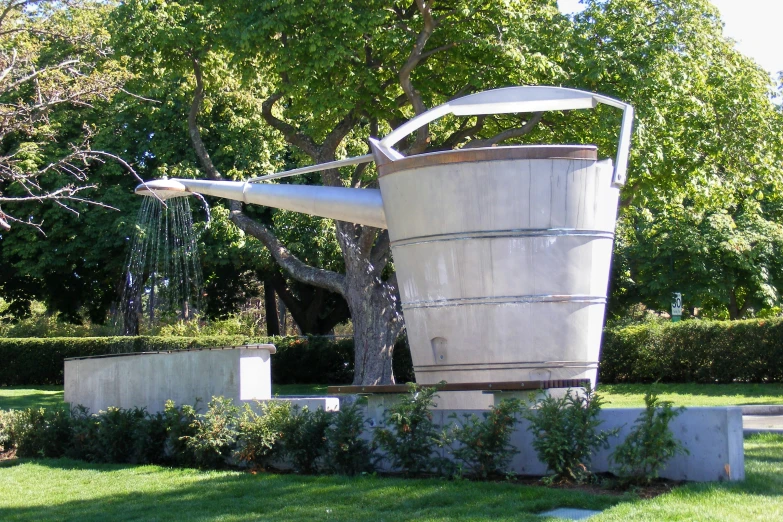 a watering can sitting on top of a park bench