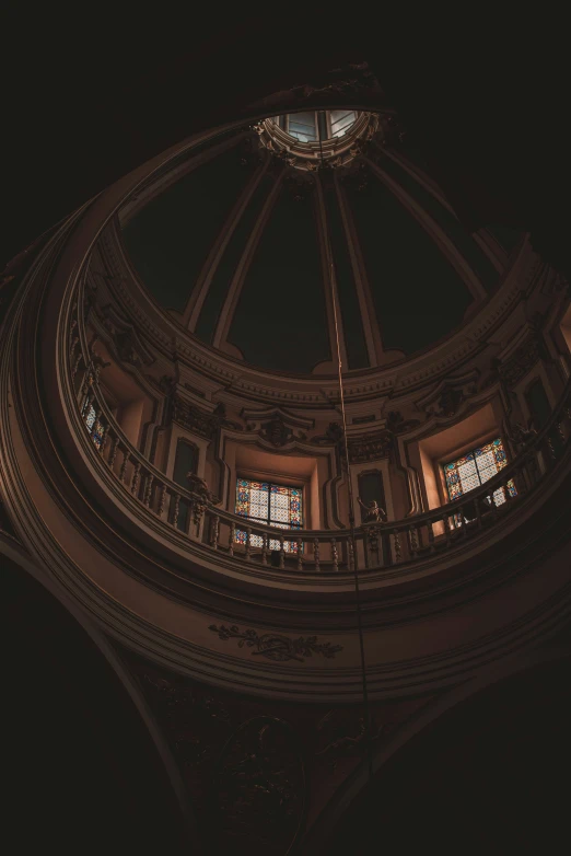 the inside of an ornate round building with stained glass windows