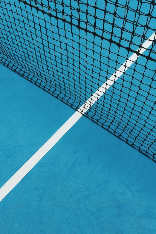 a tennis court net with an orange and white tennis ball