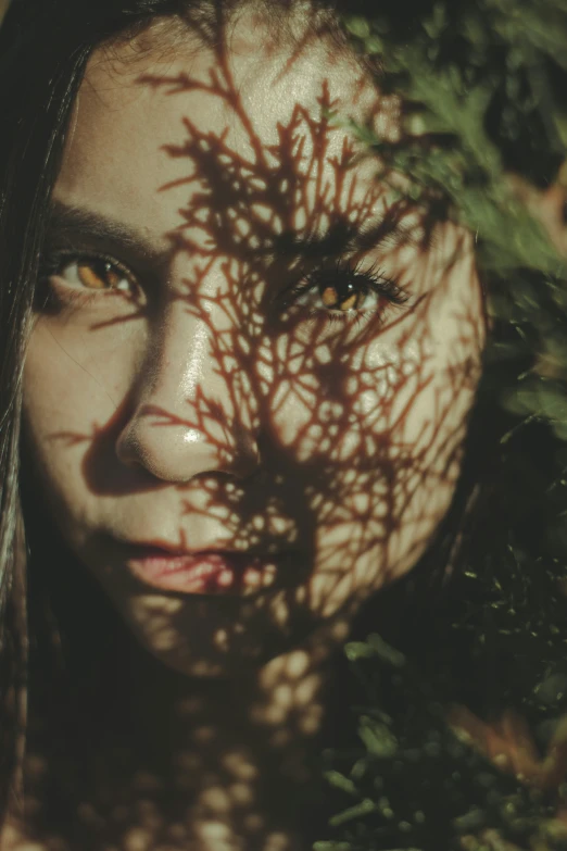 an image of a woman's face with leaves on it