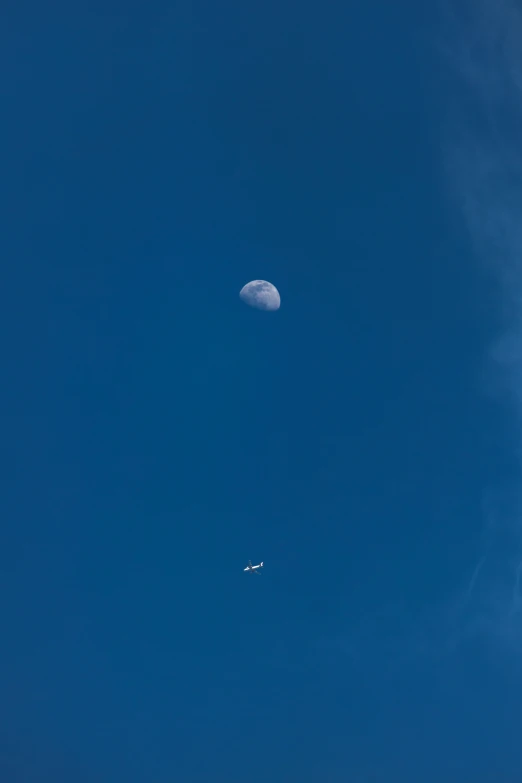 the jet and the moon are passing each other