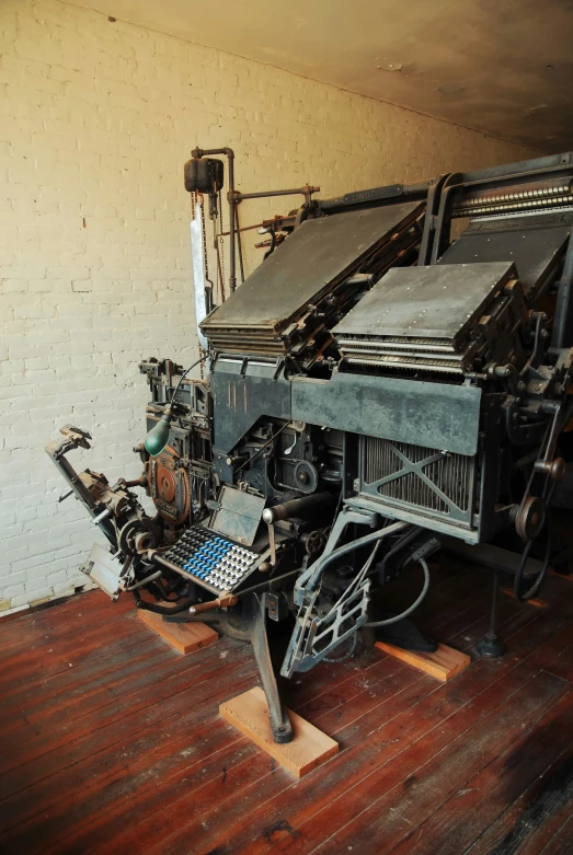 an old typewriter on a wooden floor inside a building