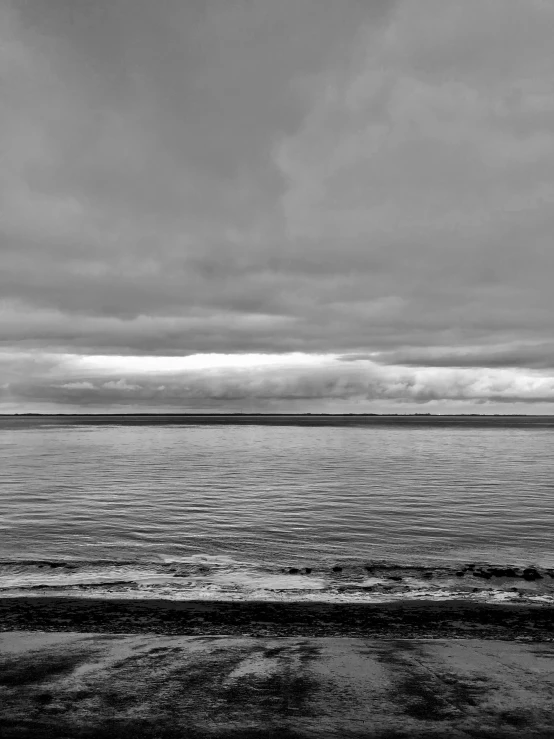 a boat traveling on the sea on a cloudy day