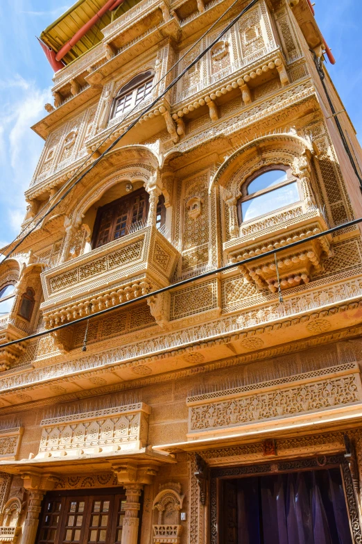 a gold building with balconies and lots of windows