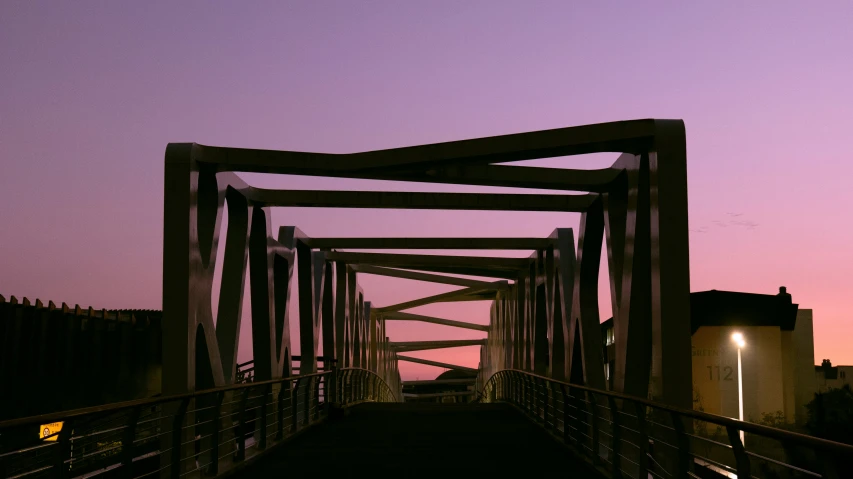 a road going down a small, narrow bridge