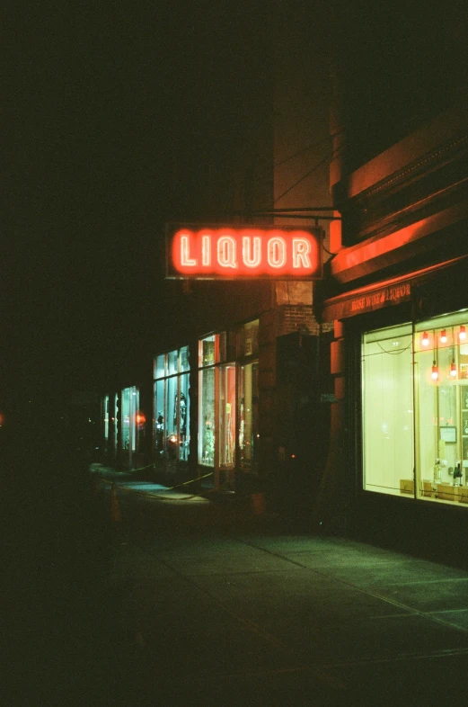 this liquor store at night is lit up red