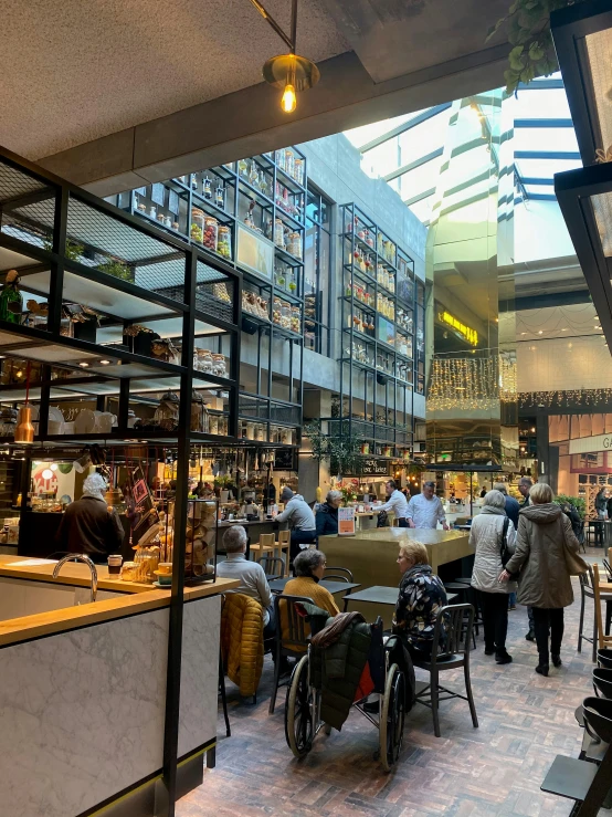 many people in a shopping mall looking for things to eat