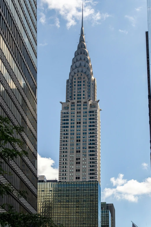 a view of a building from a street near other buildings