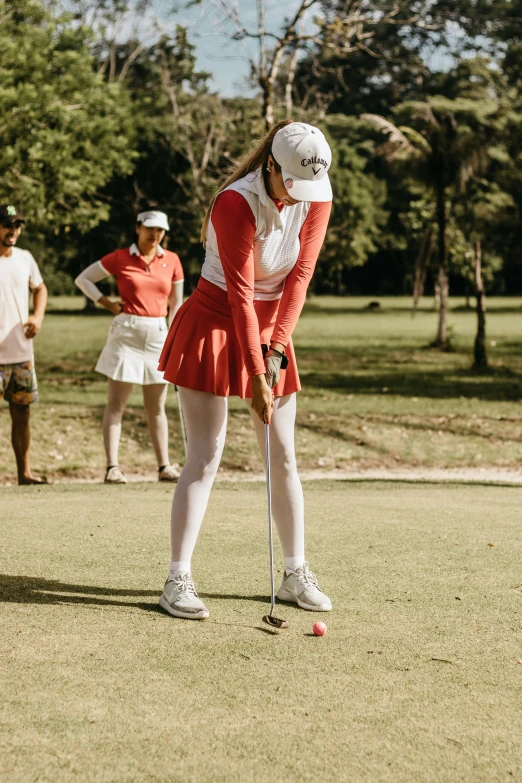 an image of a woman golf player taking a swing