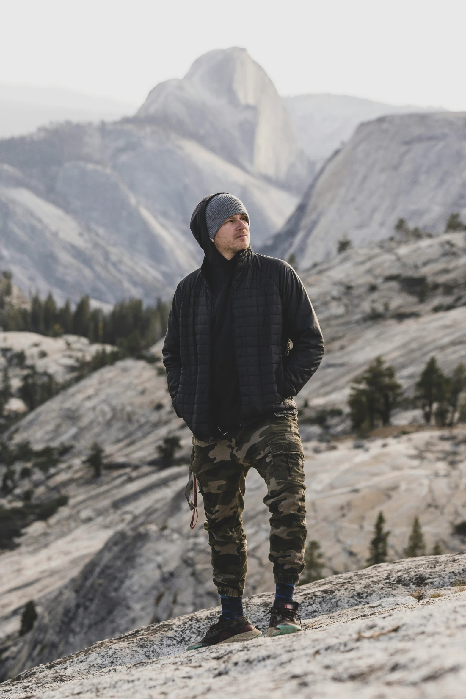 a man stands on a mountain looking away