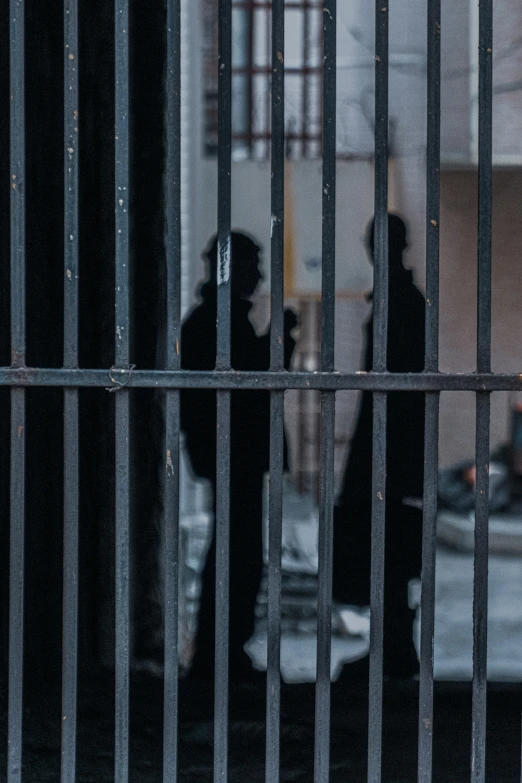 two people standing behind a barcode door