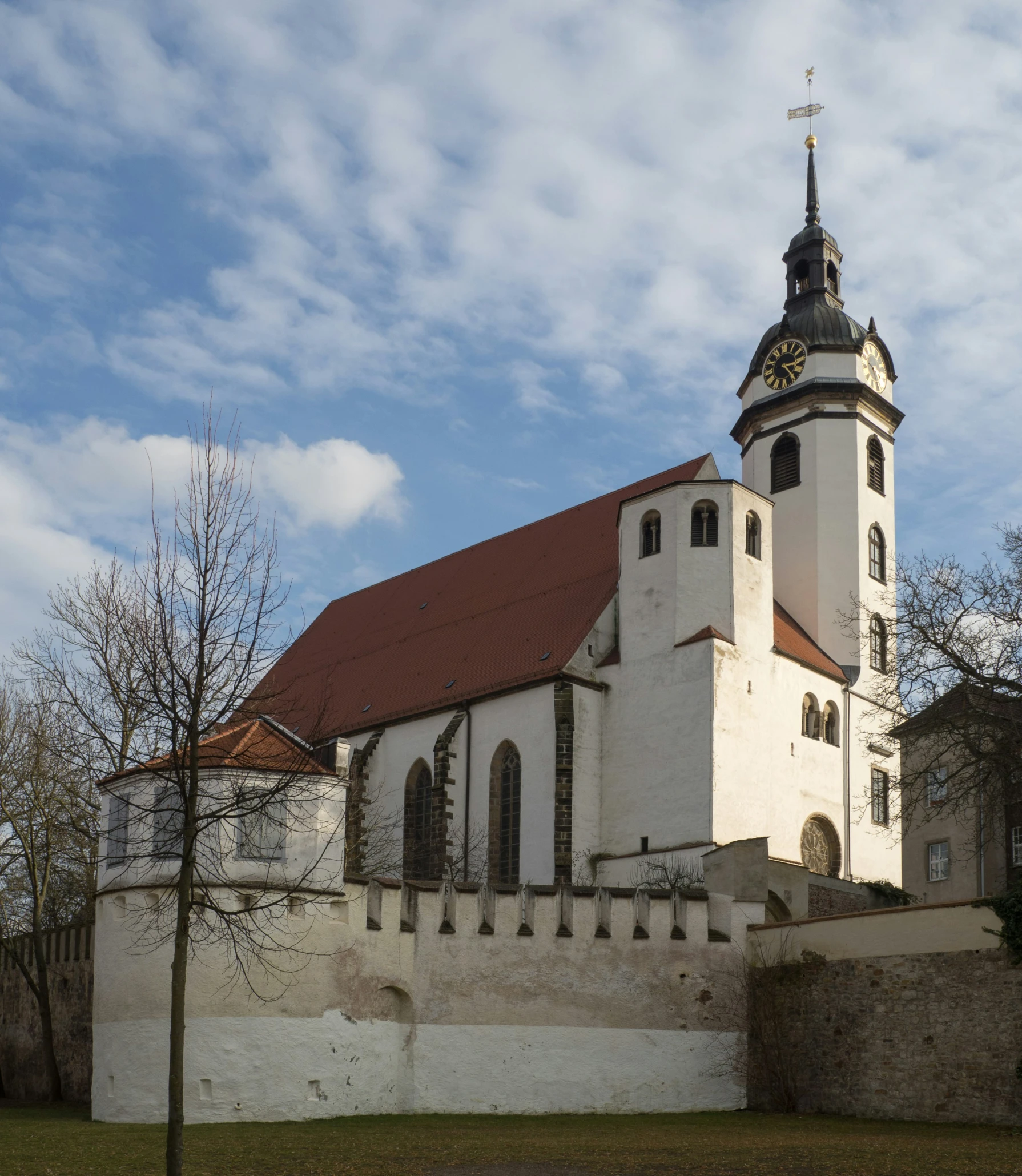 a church is in the distance and with a clock tower