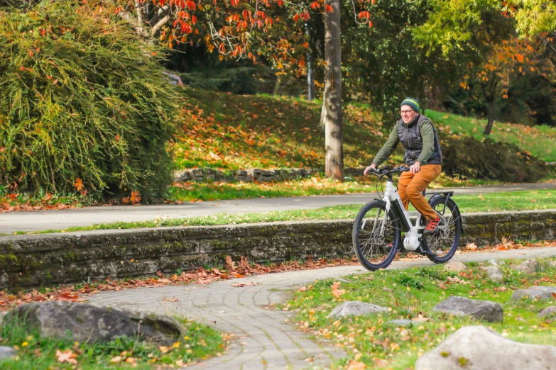 a man is riding his bicycle in a park