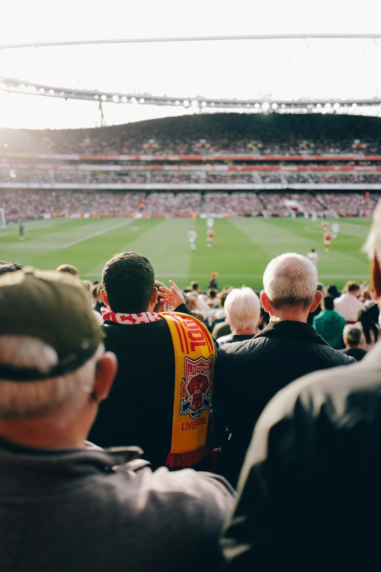 an outdoor soccer stadium with people watching the game