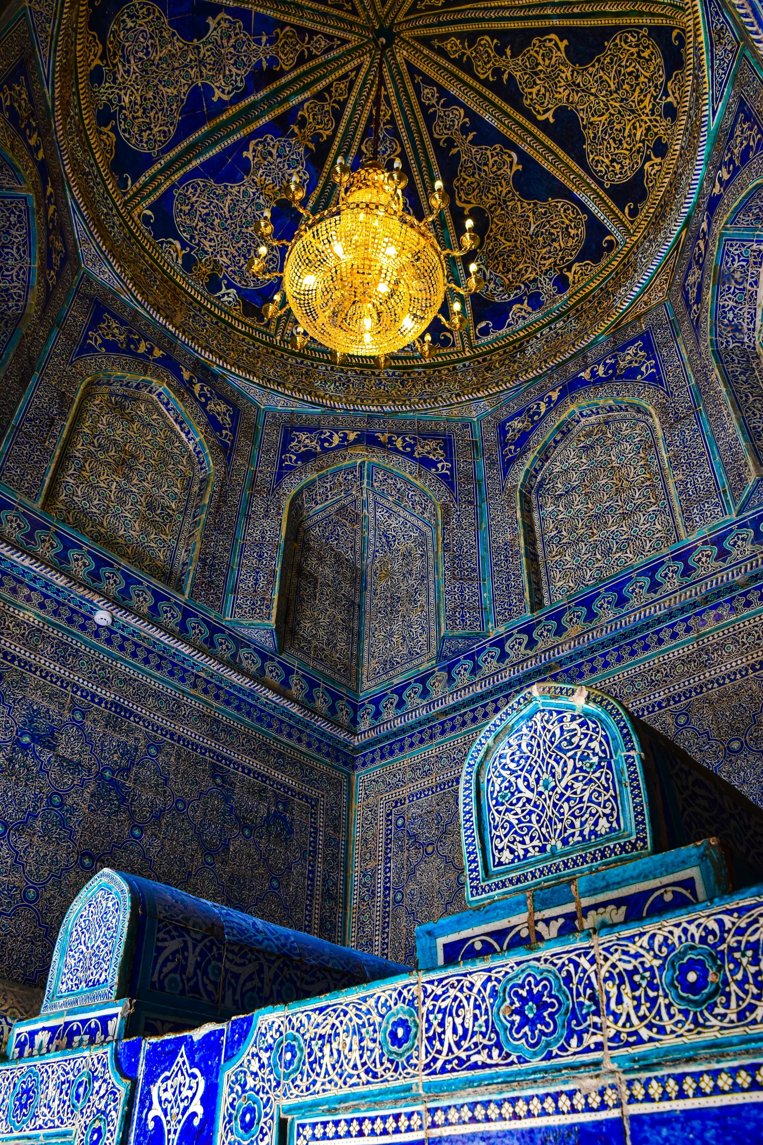 an ornately decorated interior with a chandelier and blue color