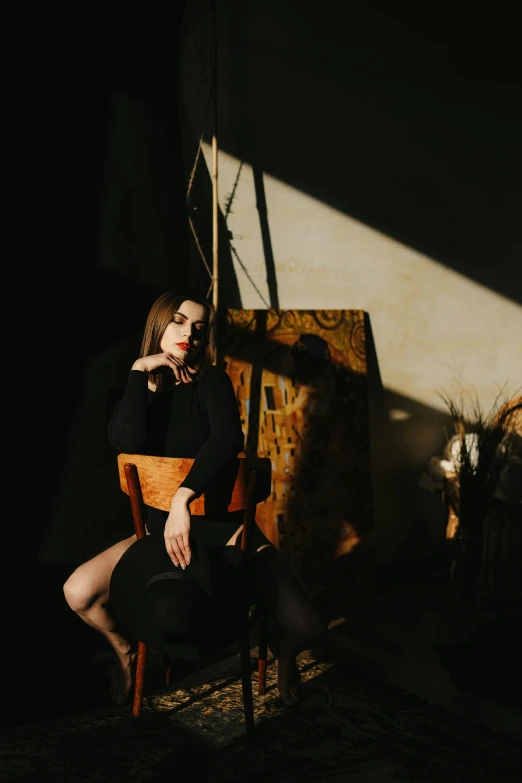 a woman sitting in a chair in a dimly lit room