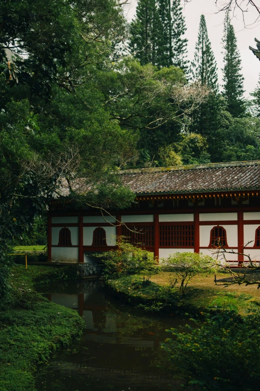 a asian building with a pond next to it