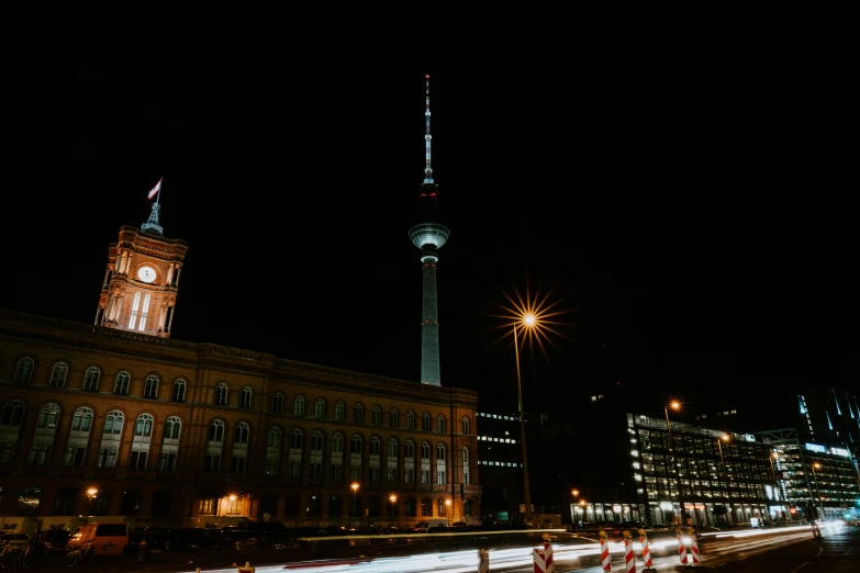 a big clock tower that is next to a very large building