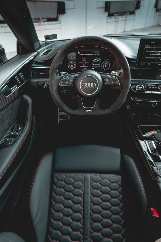 the front dash of a sports car with controls, steering wheel and dashboard