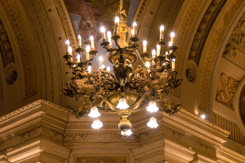 large chandelier hanging from an ornate ceiling in a building