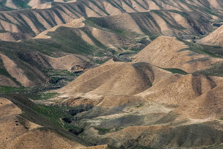 mountains are seen from a plane window as it flies through the sky