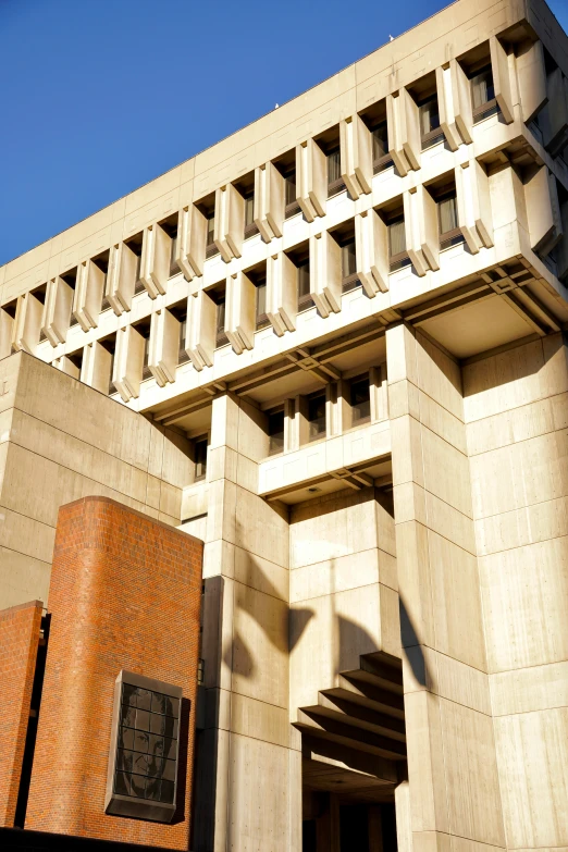 a grey brick building next to a cement wall