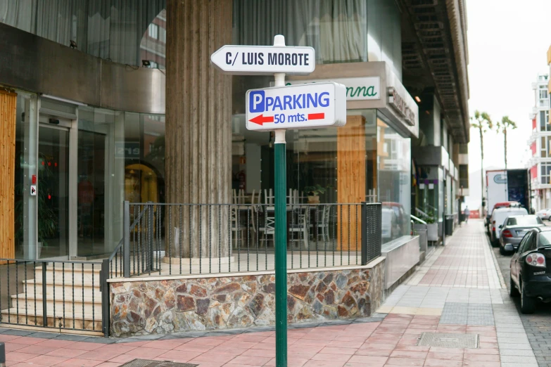 two street signs and a sidewalk on the side of the road