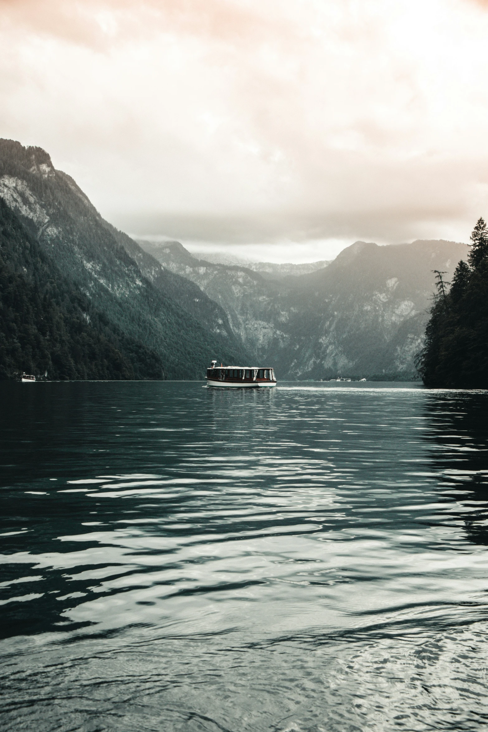 a boat on water in the middle of mountains