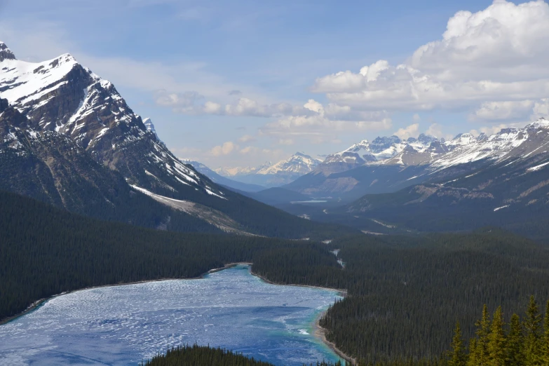 a body of water surrounded by mountains with snow on them