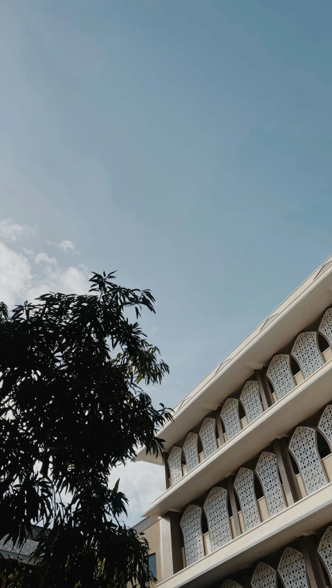 a building has a clock and is surrounded by many trees