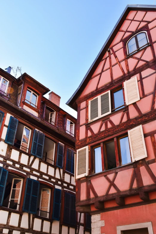 an old house with an ornate pink wall