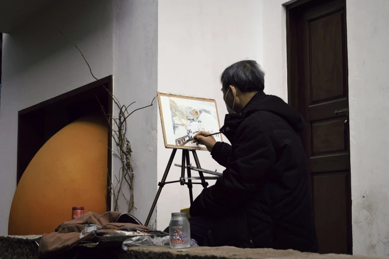 a person doing a painting in an art studio