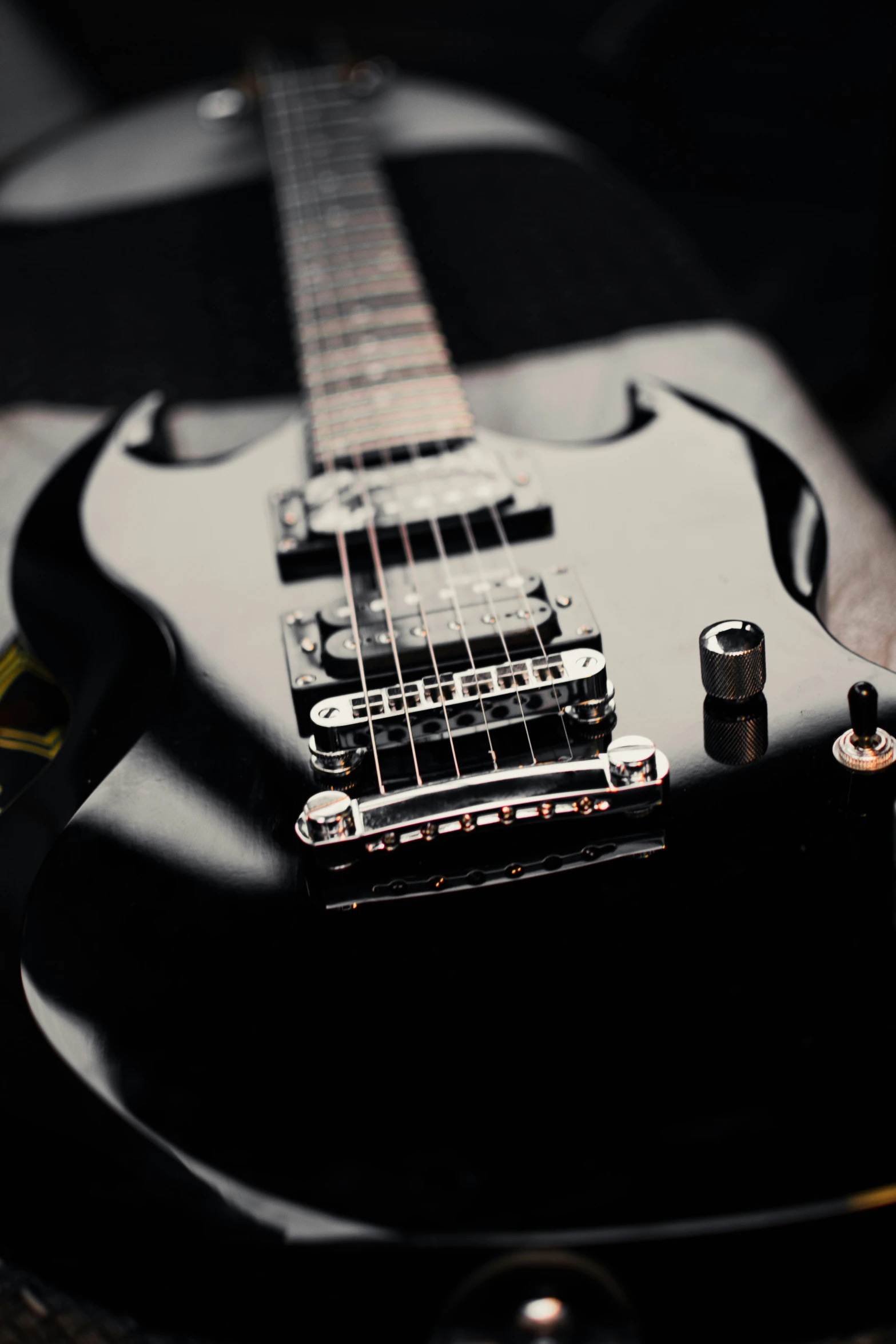 a close up of an electric guitar with a black color