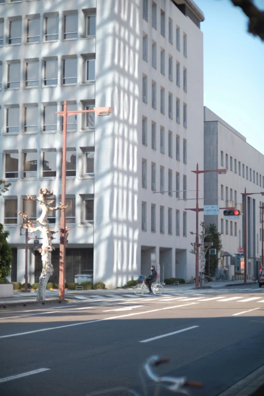 the person is waiting to cross the street at the corner