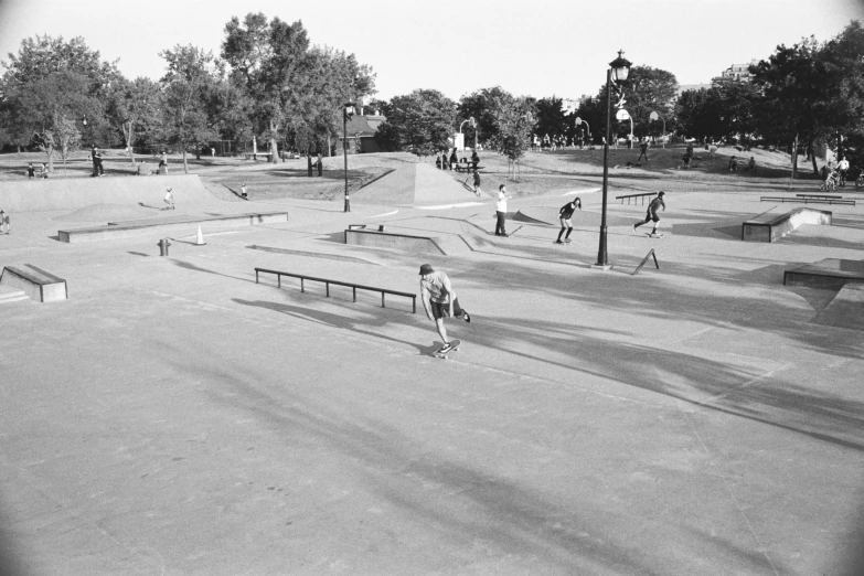 people at the skate park in black and white