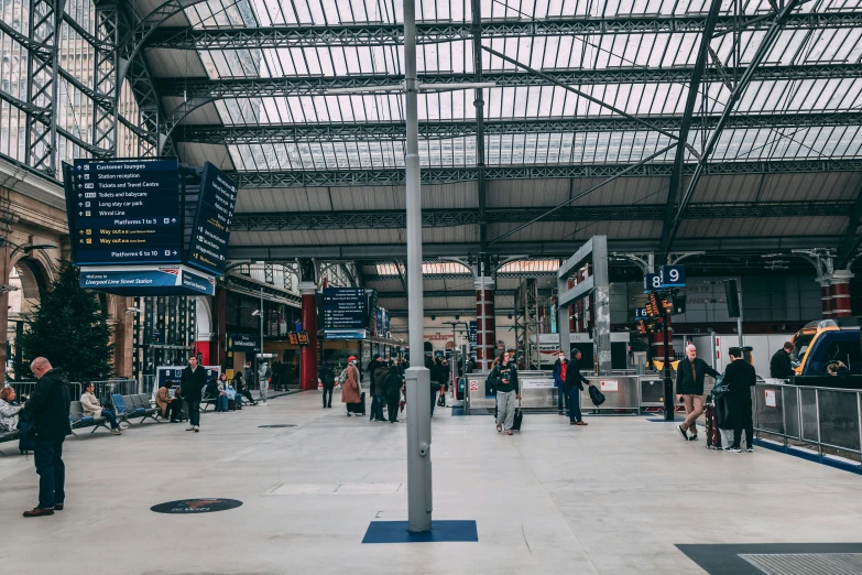 a group of people are in the middle of a train station