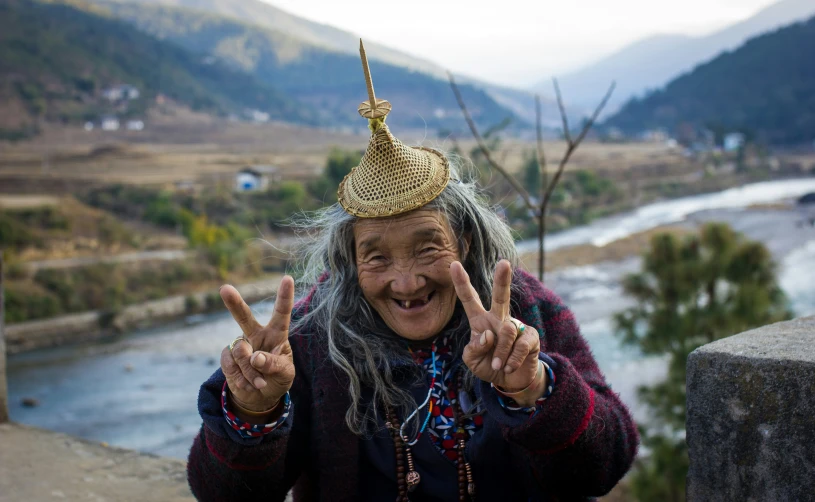 an old person making a peace sign with his fingers