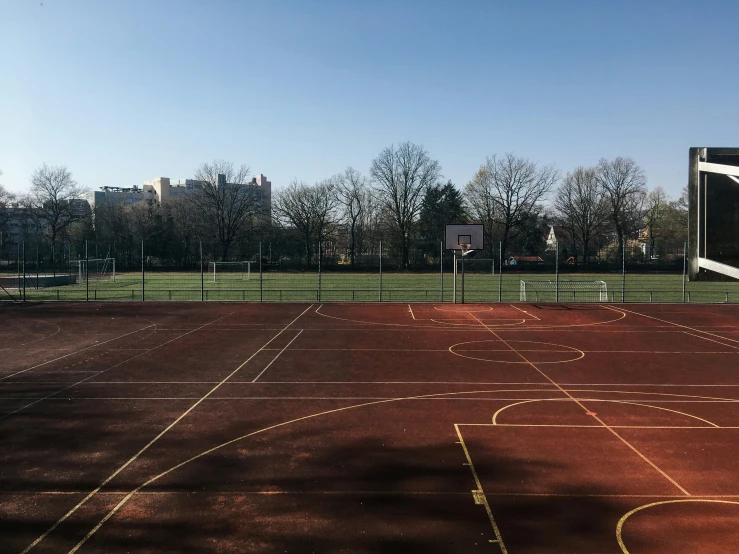 an empty tennis court is seen in the sunlight