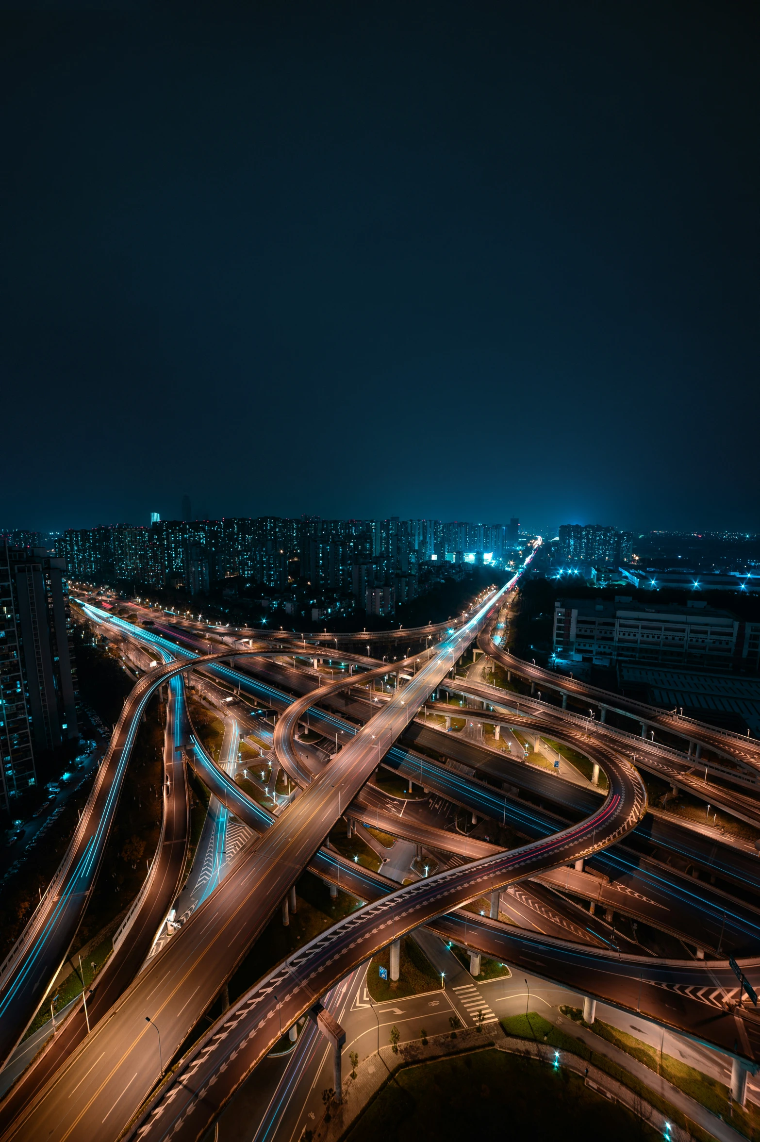 a freeway that is going over a bridge in the night