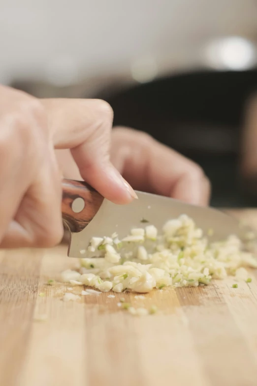 a close - up s of someone using a knife to cut the onions