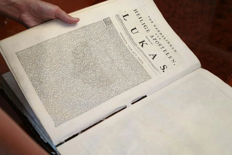 a hand is placing a page on top of the book